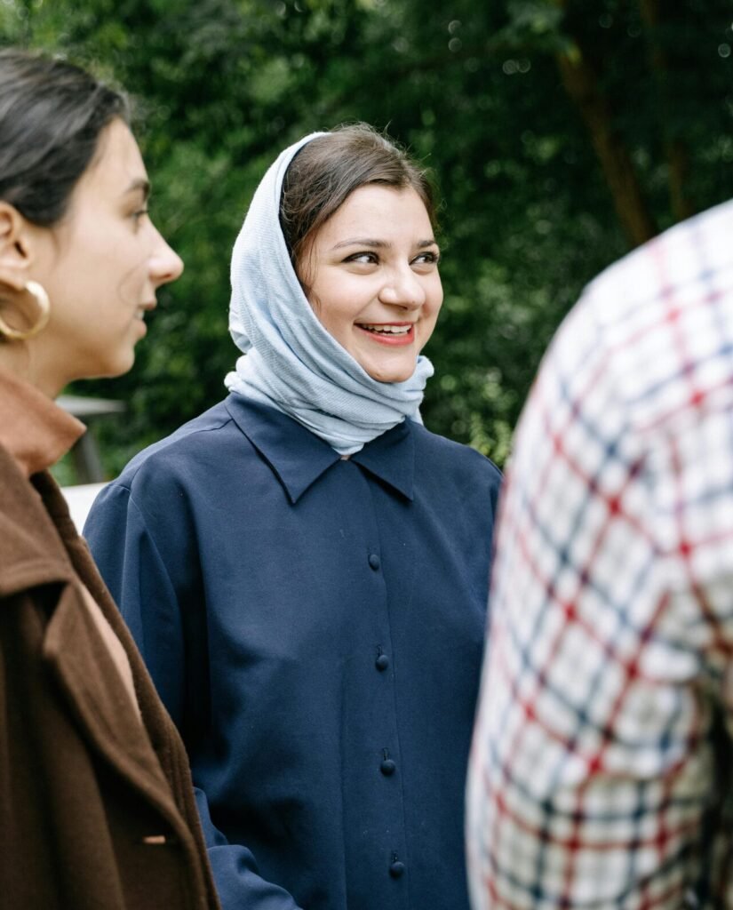 Group of diverse friends socializing outdoors, enjoying leisure time and conversation.